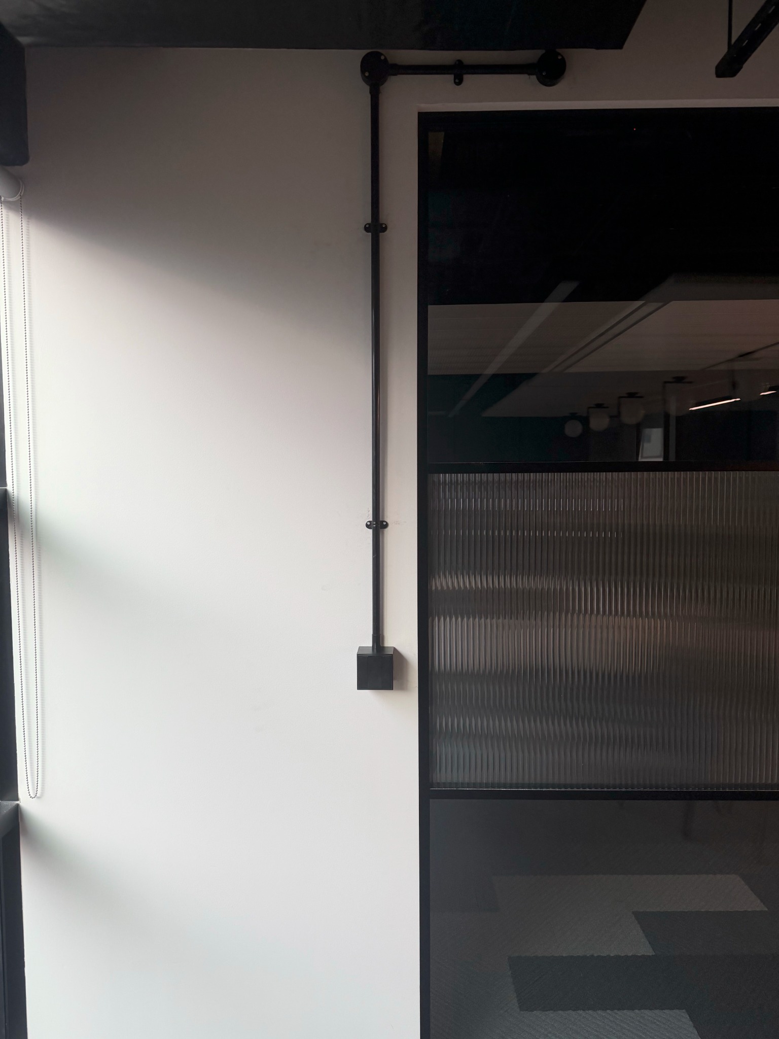 Black surface conduit installation at Cannon Street commercial office project